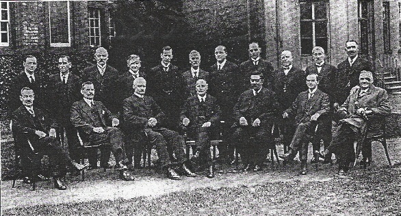Two rows of men posed outside council building