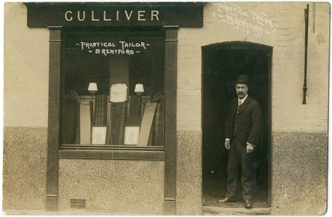View of a tailor's shop 'GULLIVER' with the owner in the doorway