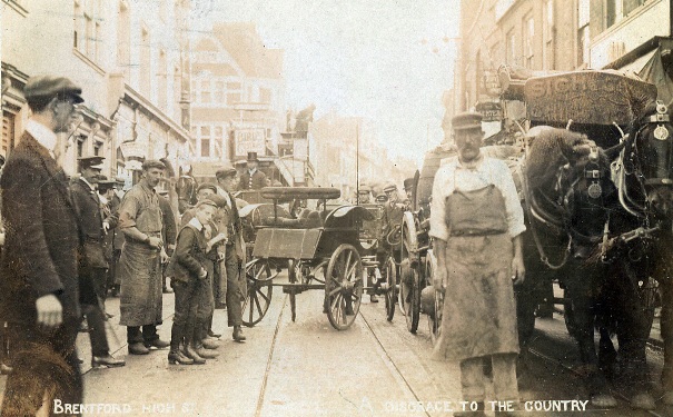Street scene with horses, wagon, carts and a tram competing for space