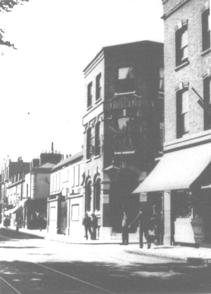 3 storey brick built pub on corner, plaque 'The BULL INN'