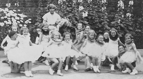 Happy group of small girls with their teacher