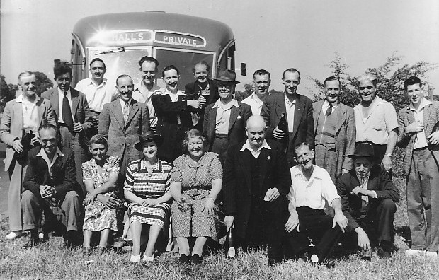 Group photo of 20 people (just 3 ladies) with a Hall's coach