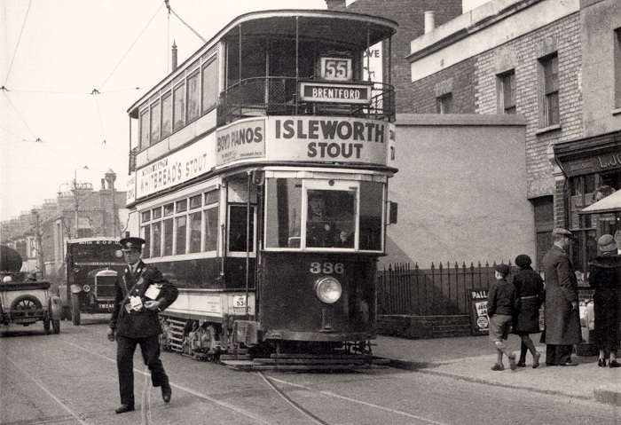 Tram in street, boot and shoe shop nearby