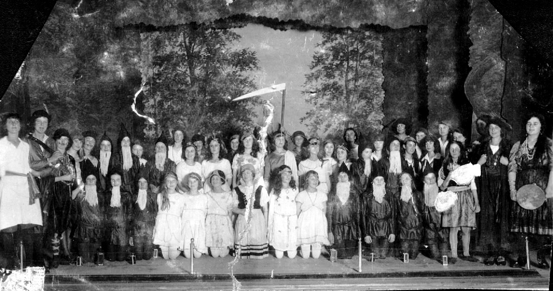 Cast of nearly 50 costumed girl performers on stage