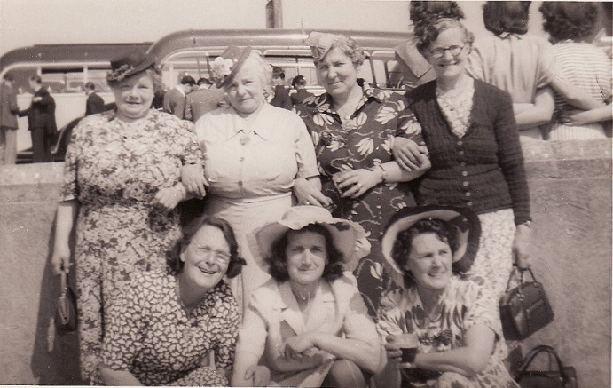 Group of seven ladies in summer dresses