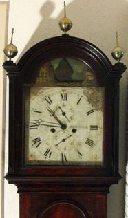 Early 19th century longcase clock; the ship goes back and forth over the dials
