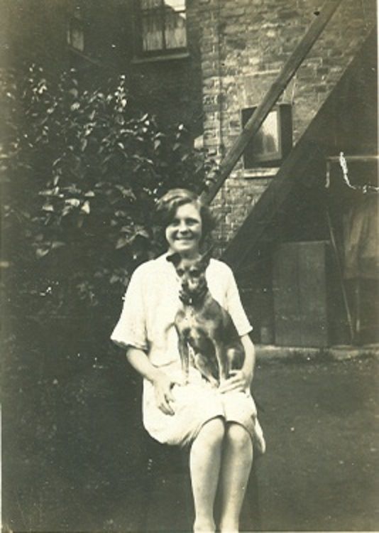 Winifred Ker sitting with a terrier on her lap
